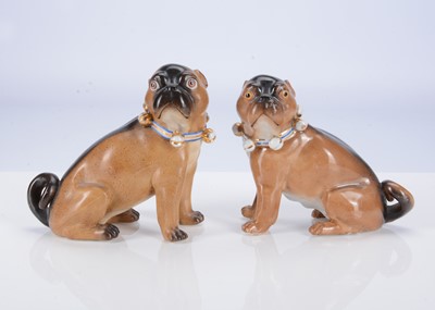 Lot 403 - A pair of Conte & Boehme porcelain seated pug dogs, circa 1900