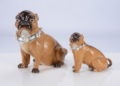 Lot 404 - A large and small Conte & Boehme porcelain seat pug dogs