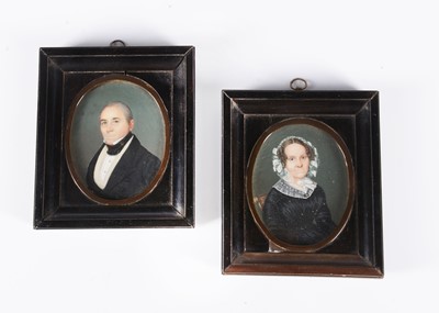 Lot 431 - A pair of 19th century husband and wife portrait miniatures on ivory