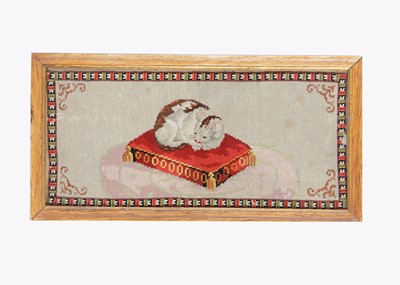 Lot 459 - An 19th century wool work of a tortoiseshell cat asleep on a cushion