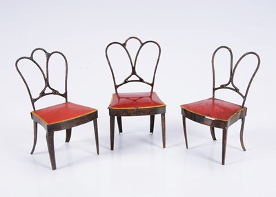 Lot 581 - Three 19th century Rock & Graner painted tinplate dolls’ house dining chairs