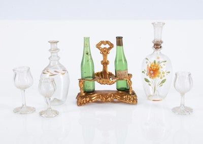 Lot 605 - An 19th German gilt metal tantalus with green glass bottles