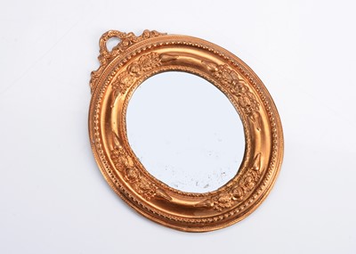 Lot 617 - A late 19th century German gilt metal dolls’ house oval mirror
