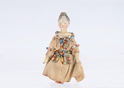 Lot 649 - An 19th century Grodnertal carved wooden small dolls’ house comb tuck doll