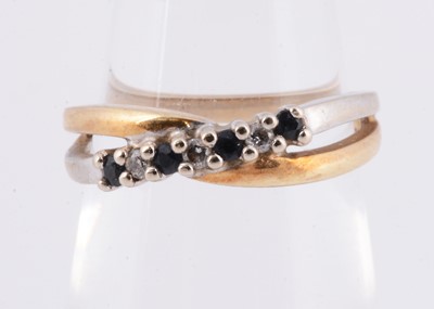 Lot 1 - A 10k gold sapphire & diamond seven stone two row crossover ring