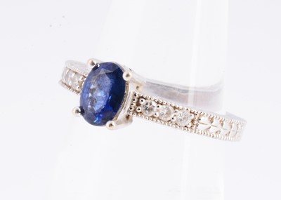 Lot 3 - A 14k gold oval sapphire & diamond dress ring