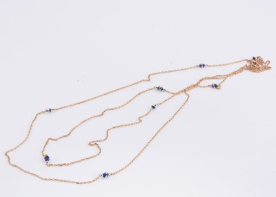 Lot 26 - An Edwardian gold opera length chain with lapis, pearl & rock crystal torpedoes