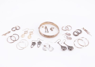 Lot 58 - A silver hinged bangle together with a collection of silver earrings