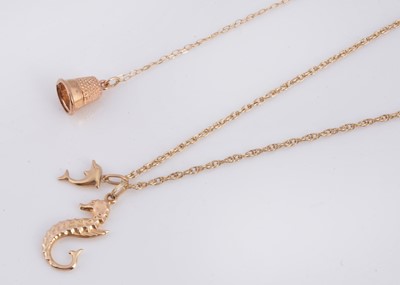 Lot 74 - A 9ct gold seahorse pendant necklace, together with a thimble pendant necklace