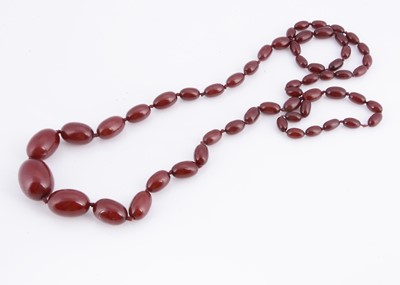 Lot 75 - A strand of Art Deco graduated cherry amber beads