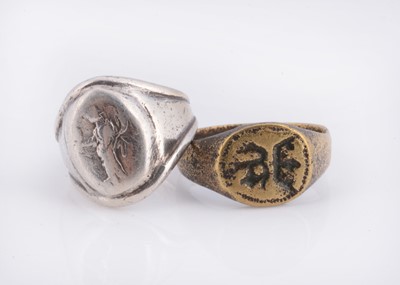 Lot 79 - A white metal signet ring & a brass example