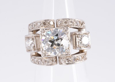 Lot 124 - An Art Deco platinum diamond stylised buckle ring