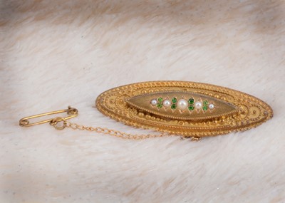 Lot 171 - A 15ct gold seed pearl and demantoid garnet oval brooch with box back