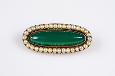 Lot 182 - A early 20th century green chalcedony seed pearl yellow metal oval brooch