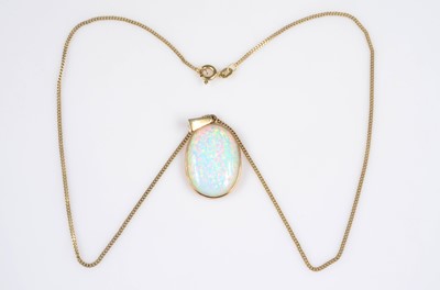 Lot 183 - A synthetic opal & gold mounted pendant of oval design