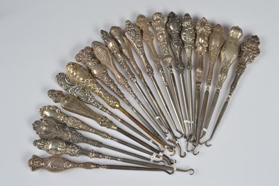 Lot 199 - Twenty ornate silver handled steel button hooks