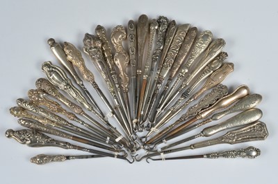 Lot 204 - Thirty silver and white metal handled steel button hooks