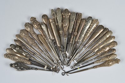 Lot 205 - Thirty silver and white metal handled steel button hooks