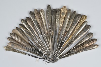 Lot 208 - Twenty five silver and white metal handled steel button hooks