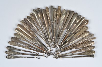 Lot 209 - A collection of silver and white metal handled steel button hooks