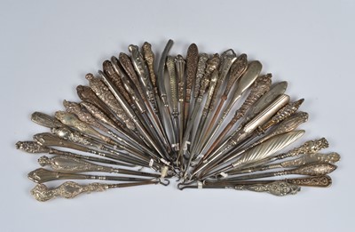 Lot 212 - A collection of silver and white metal handled steel button hooks