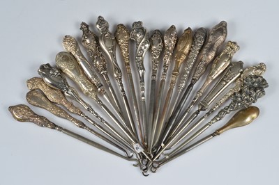 Lot 213 - Twenty ornate silver and white metal handled steel button hooks