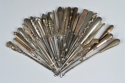 Lot 214 - Twenty six silver and white metal handled steel button hooks