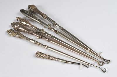Lot 225 - Six silver handled push button hinged folding steel button hooks
