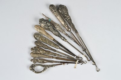Lot 227 - Eleven figural handled button hooks