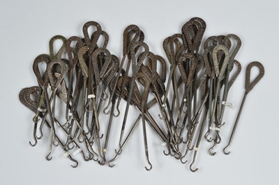 Lot 242 - A collection of steel advertising button hooks
