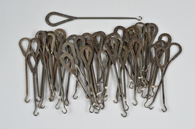 Lot 246 - A collection of steel advertising button hooks