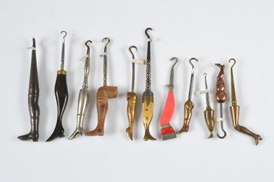 Lot 254 - A collection of eleven small novelty button hooks in the form of legs