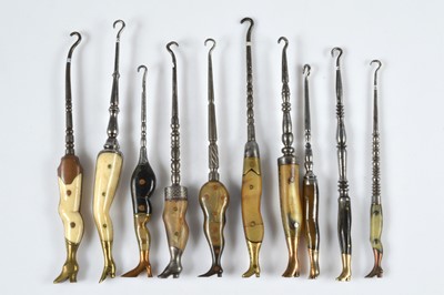 Lot 255 - A collection of ten bone and horn handled novelty button hooks