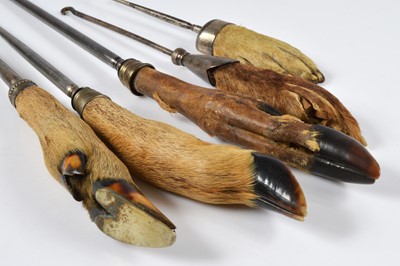 Lot 257 - A collection of early 20th Century taxidermy fox, deer and other pad handled button hooks