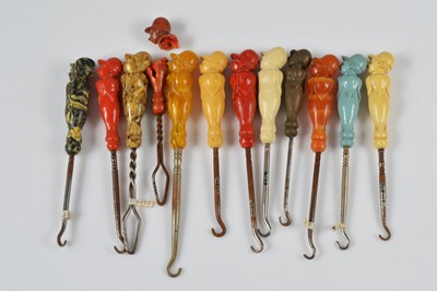 Lot 263 - A collection of antique celluloid figural button hooks and loops
