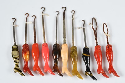 Lot 264 - A collection of antique celluloid boot handled button hooks and loops