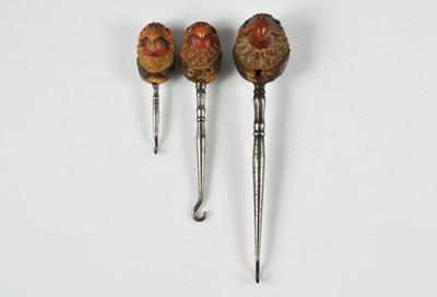Lot 273 - A collection of carved nut handled button hooks