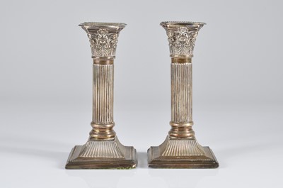 Lot 375 - A pair of Edwardian silver filled column candlesticks by JS & S