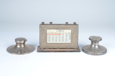 Lot 396 - An Art Deco period silver mounted perpetual desk calendar and two capstan inkwells