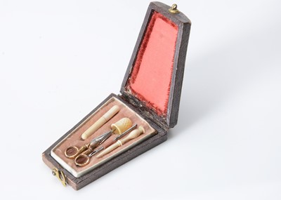 Lot 327 - An 19th century tooled leather  miniature dolls’ nécessaire