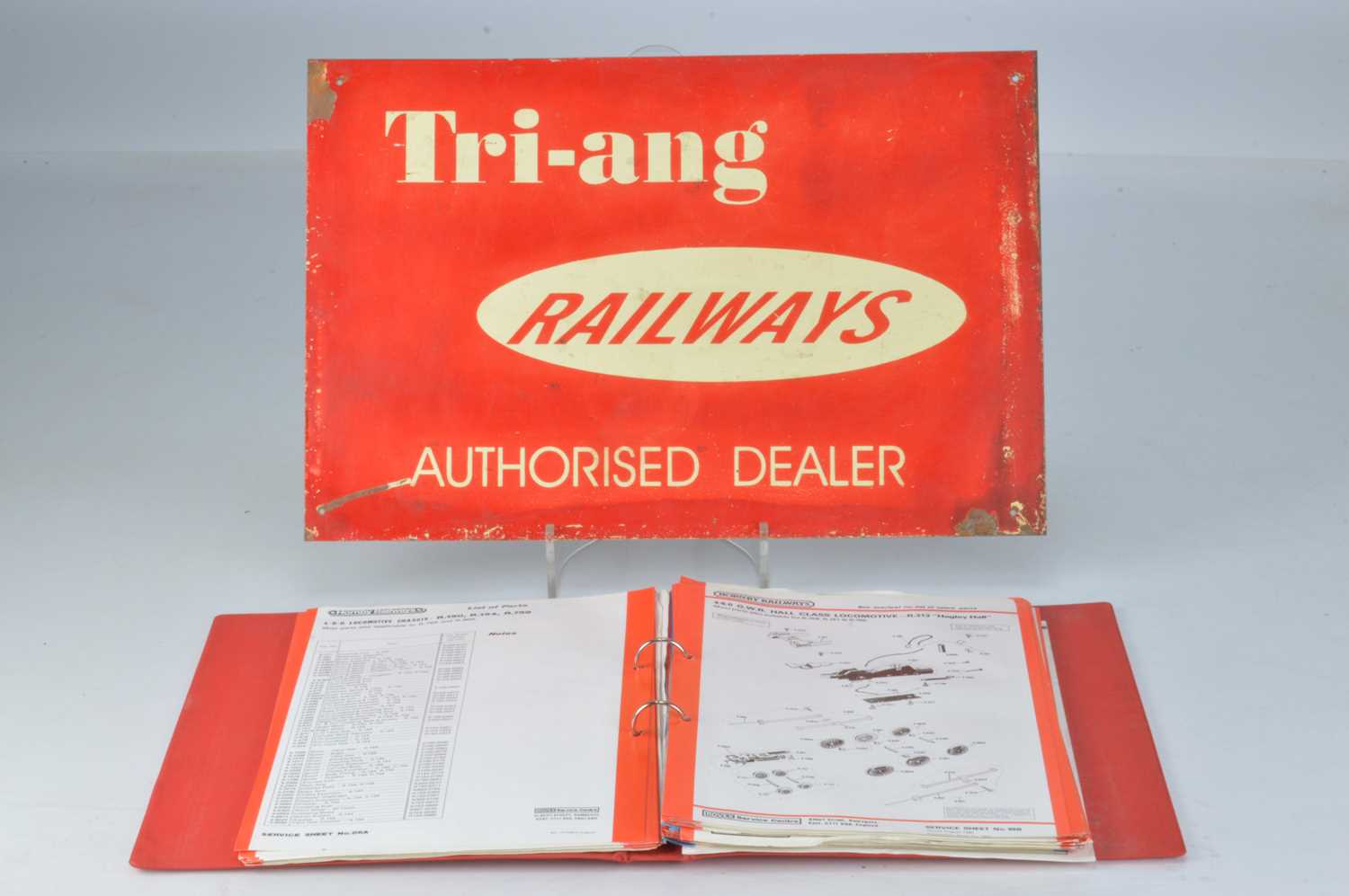 Lot 56 - Original Tri-ang Railways one sided red Authorised Dealer sign and 1980's Hornby Hobbies Service Sheets in a red folder (qty)