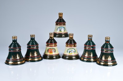 Lot 739 - A collection of seven Bells 8 Year Old Christmas Decanters