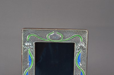 Lot 177 - A modern Arts and Crafts style silver and enamelled photograph frame