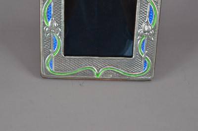 Lot 177 - A modern Arts and Crafts style silver and enamelled photograph frame