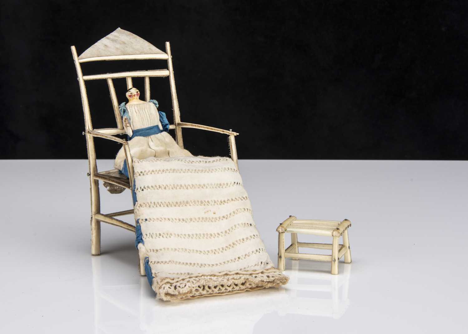 Lot 110 - A 19th century Grodnerthal dolls’ house baby in feather chair