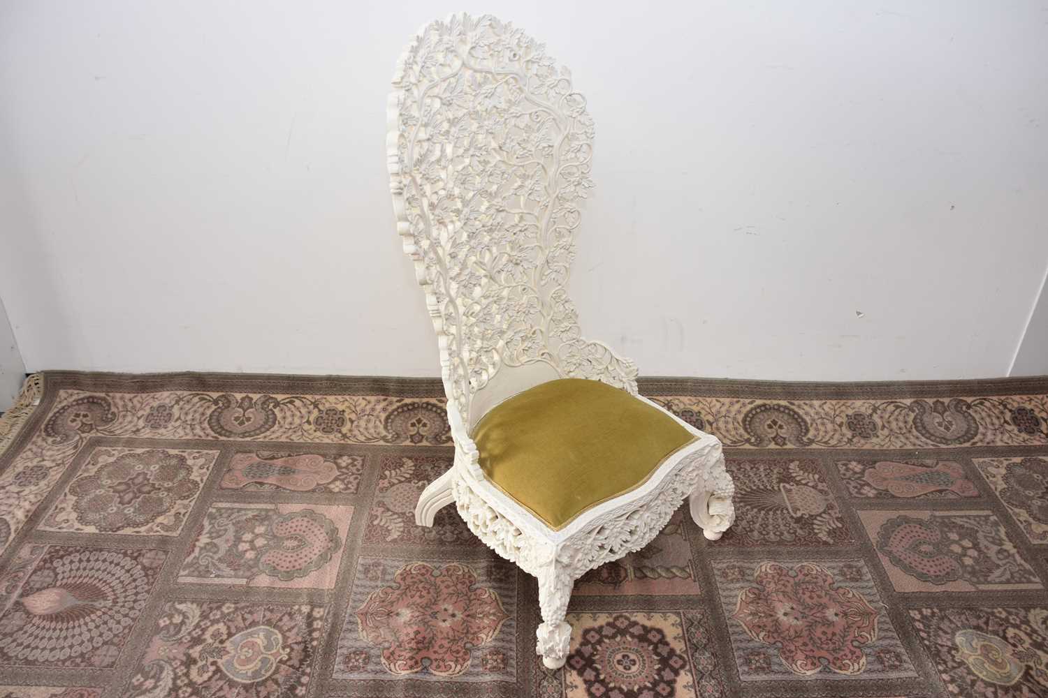 Lot 93 - A later painted Victorian period Anglo-Indian carved hardwood high back chair