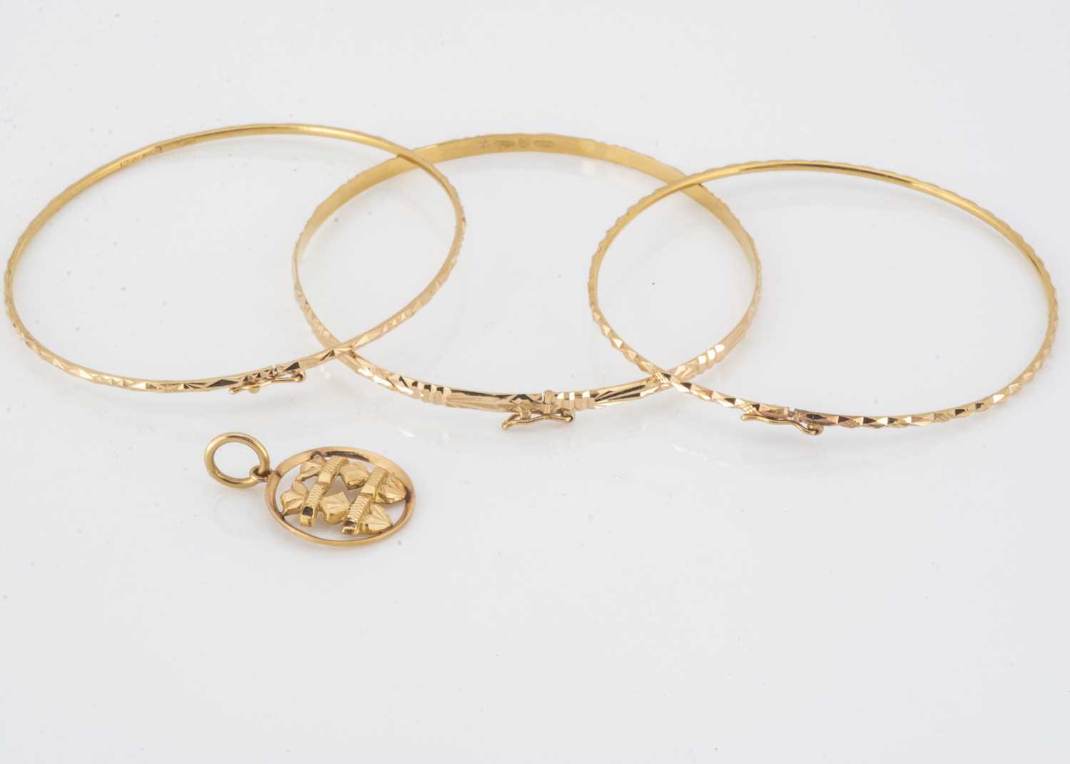 Lot 66 - Three continental yellow metal bangles