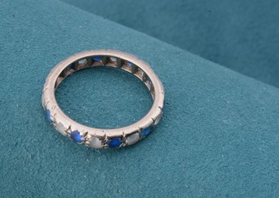 Lot 61 - A white 18ct gold sapphire and colourless paste eternity ring