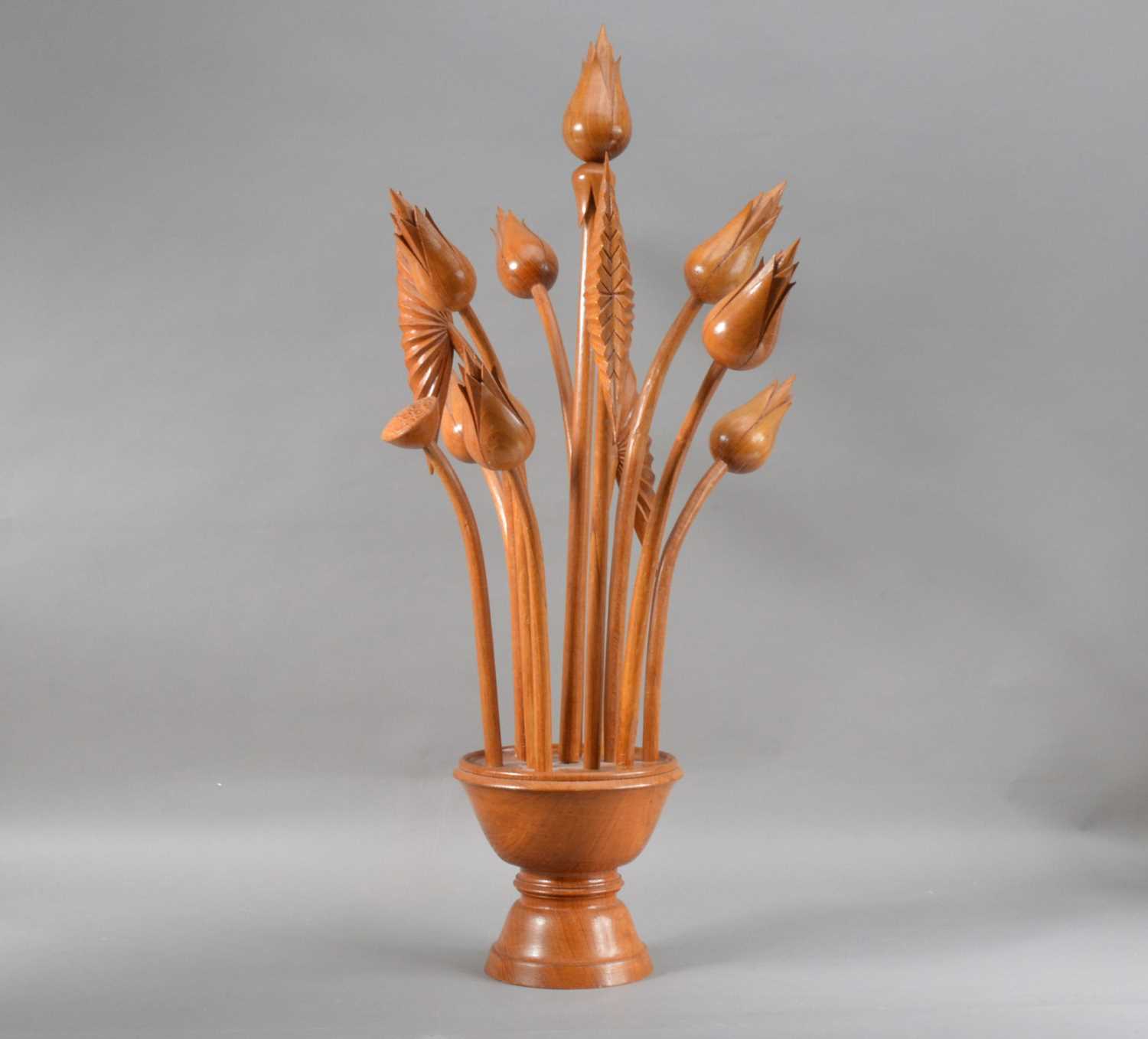 Lot 127 - A carved hardwood sculpture of flowers