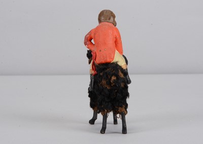 Lot 3 - A late 19th century German composition monkey riding a poodle candy container